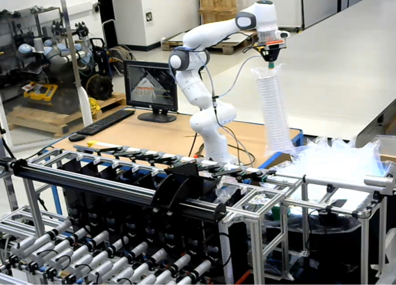 Robotic arm working alongside an industrial conveyor setup